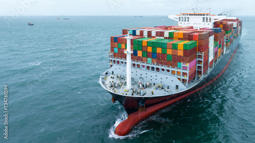 front view Cargo Container ship with contrail in the ocean ship carrying container and running for import export concept technology freight shipping by ship