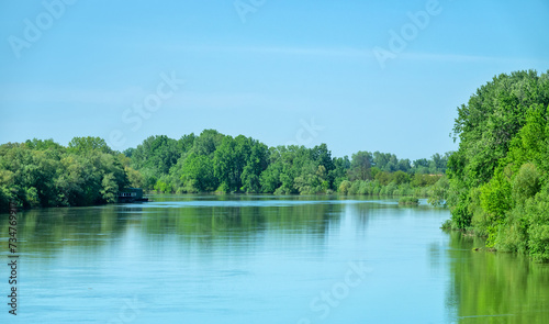 Potamology. The Kuban River in the lower reaches, sluggish river but course, end of spring flood. The floodplain forest consists mainly of black poplar and white willow. Krasnodar Territory, Russia photo