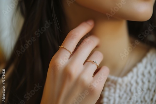 closeup of womans finger wearing a midi ring photo