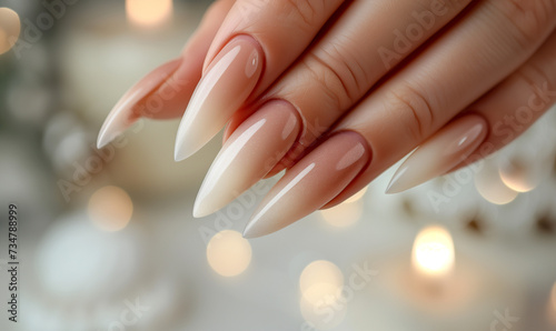 Closeup of woman hand with nude manicure in a nail studio  nail salon