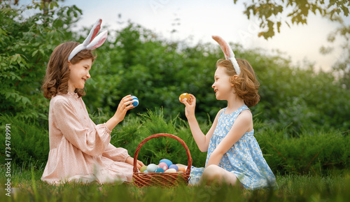 children with painting eggs outdoors
