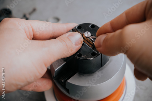 Goldsmith hands with ring. Work in process.
