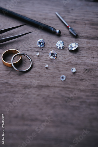 Different gemstones, gold rings on metal background, copyspace goldsmith