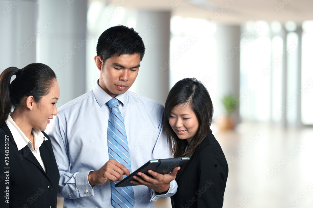 Asian Business people using a digital touch pad Asian Business people using a digital touch pad