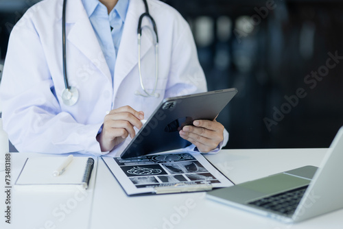 Asian female doctor working with tablet and health personal data in modern clinic  Healthcare and medical concept.