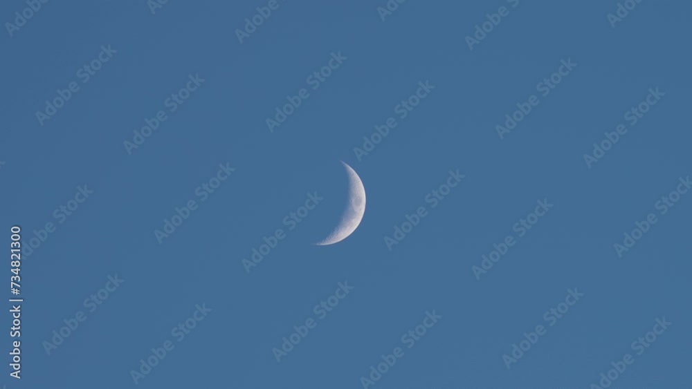 Wide Shot Of The Skies With A Pale Waxing Crescent Moon. Wide Shot Of The Skies With A Pale Waxing Crescent Moon.
