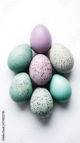 Speckled pastel Easter eggs on white background. Easter greeting card background, phone wallpaper, stories backdrop