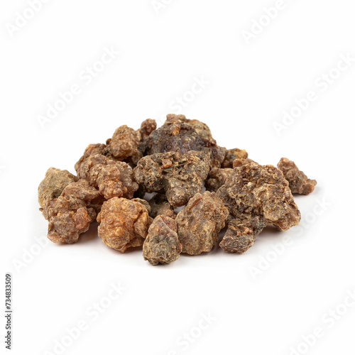 Pile of large pieces of myrrh resin on a white background.
