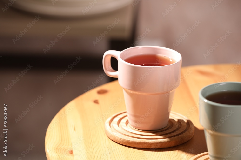 Aromatic tea in cup on wooden table, space for text Aromatic tea in cup on wooden table, space for text