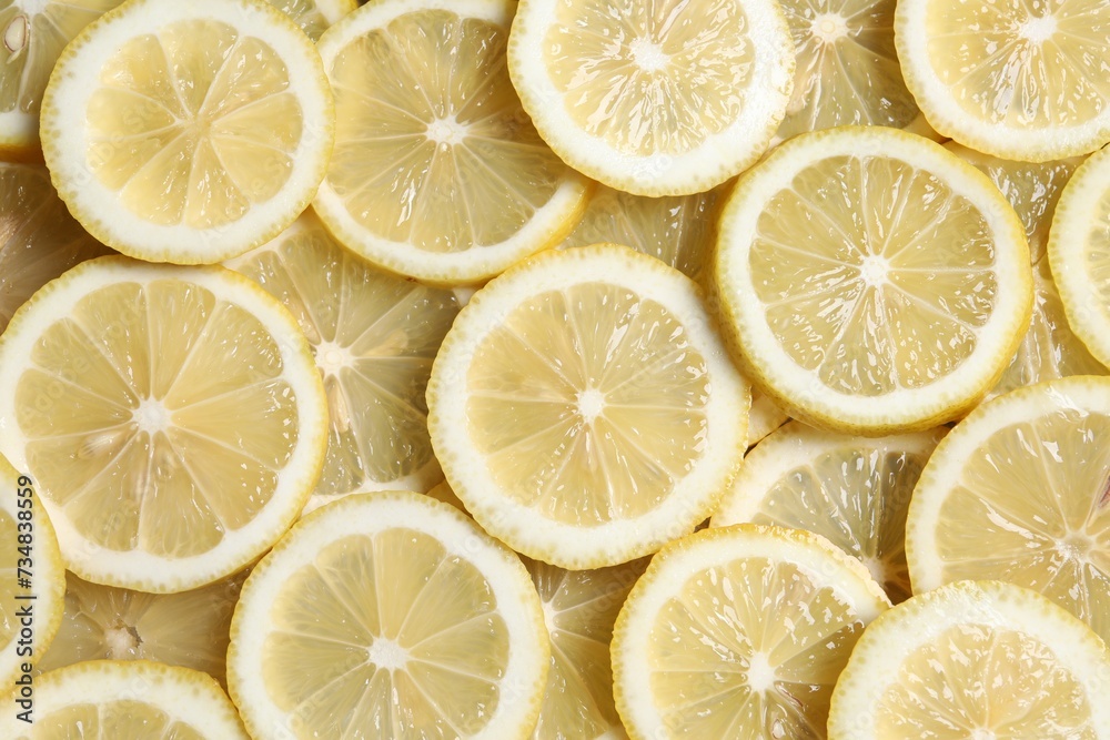 Slices of fresh lemons as background, top view Slices of fresh lemons as background, top view