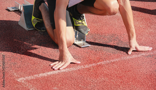 Cropped image of a sprinter getting ready to start at the stadium