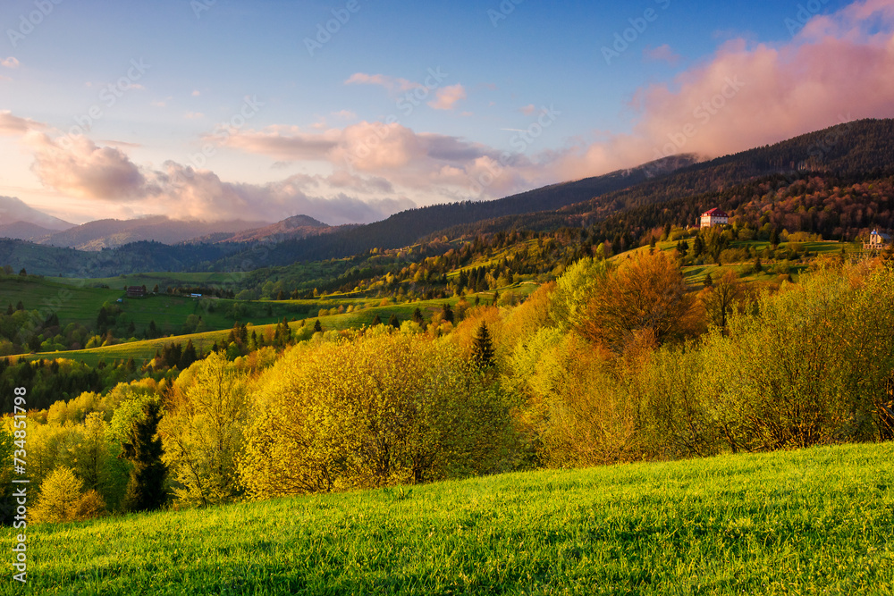 carpathian countryside scenery with forested hills in evening light. mountainous rural landscape of transcarpathia in spring