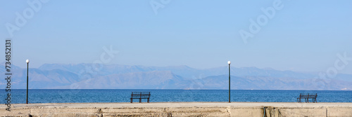 Pier with bench on the beach of Corfu Island, Greece.
