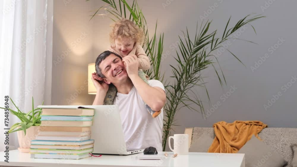 Technology in family life. Father working from home. Freelancing with kids. Caucasian man working on laptop with baby daughter on his shoulders at home Technology in family life. Father working from home. Freelancing with kids. Caucasian man working on laptop with baby daughter on his shoulders at home