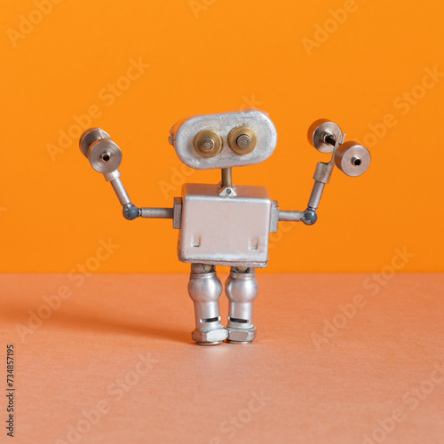 Robot athlete holds dumbbells. sports exercise fitness training