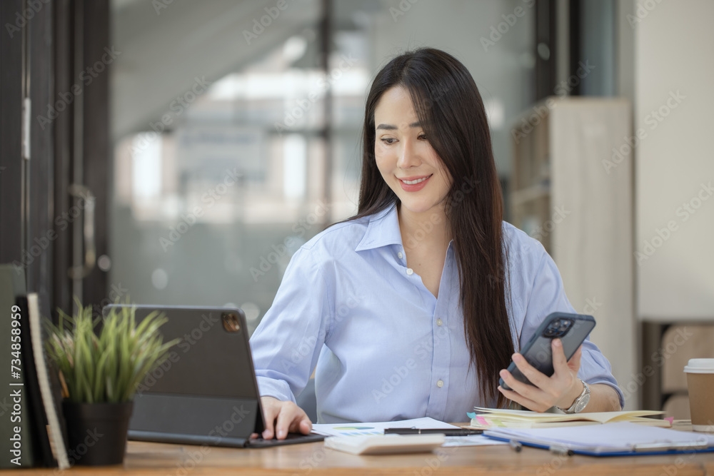 Happy asian young businesswoman excited with smartphone at workplace, Excited happy Asian woman. Happy asian young businesswoman excited with smartphone at workplace, Excited happy Asian woman.