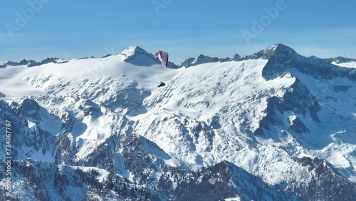 Aerial drone Winter view on dolomites alps in Italy.  Pinzolo in winter sunny day.  Paragliding mountains.
Sitting on bench in dolomites in winter. Val Rendena dolomites  Italian alps, Trentino Italy. photo