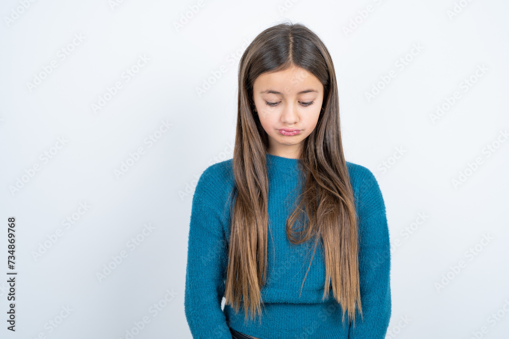 Displeased upset Young beautiful teen girl wearing blue T-shirt frowns face as going to cry, being discontent and unhappy as can't achieve goals, Disappointed model has troubles Displeased upset Young beautiful teen girl wearing blue T-shirt frowns face as going to cry, being discontent and unhappy as can't achieve goals, Disappointed model has troubles