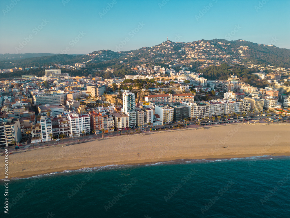 Aerial view of Lloret del Mar City. Mediterranean coastal town in Catalonia, Spain. One of the most popular Costa Brava beaches and travel destination. Sunset