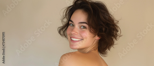 Captivating Portrait of a Young Woman With a Genuine Smile and a Neutral Backdrop