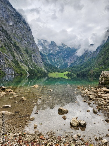 Reflection on Königssee lake with mountain view and rocks
