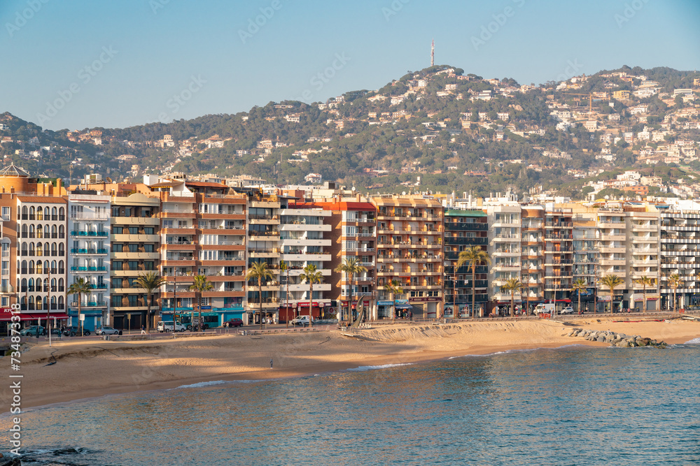 High angle view of Lloret del Mar city. Mediterranean coastal town in Catalonia, Spain. One of the most popular Costa Brava beaches and travel destination. Sunset warm colours. 