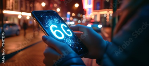 Interactive holographic 6g shining text icon displayed over a mobile phone screen in hands
