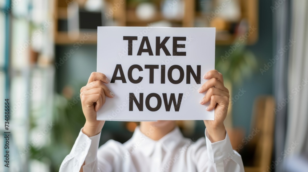 Motivational concept woman holding sign saying take action now on abstract background. Motivational concept woman holding sign saying take action now on abstract background.