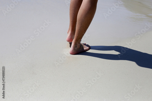 Men walking on sand beach