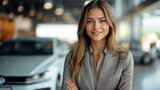 Confident professional woman with a friendly smile standing at a modern car dealership.