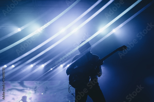 Silhouette of a guitarist with a background full of lights