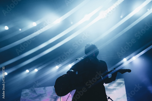 Silhouette of a guitarist with a background full of lights
