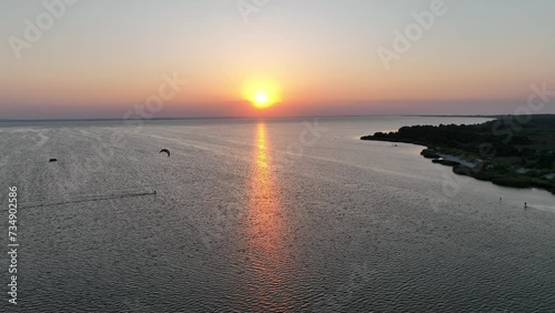 Aerial view of sunset in Hel penisula Jastarnia Puck Bay Baltic Sea. Kitesurfing at sunset. Windsurfing at sunset. Water sports at sunset on sea. photo