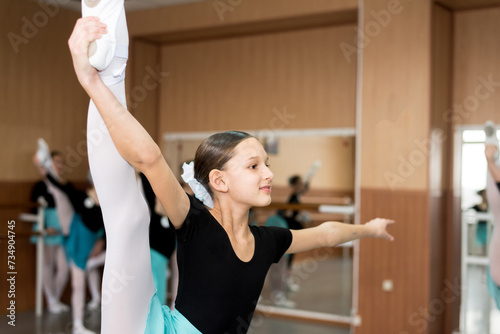 Young beautiful dancer training in the dance hall