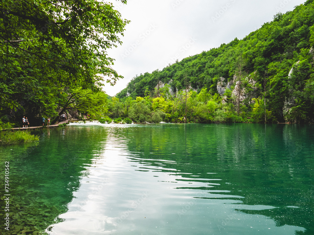 Scenic view of lush green forest and a serene river in Plitvice Lakes National Park, Croatia Scenic view of lush green forest and a serene river in Plitvice Lakes National Park, Croatia