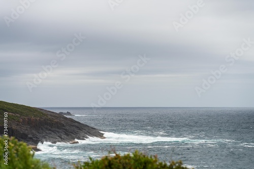 waves breaking on rocks in on the coast by the sea in tasmania australia in summer