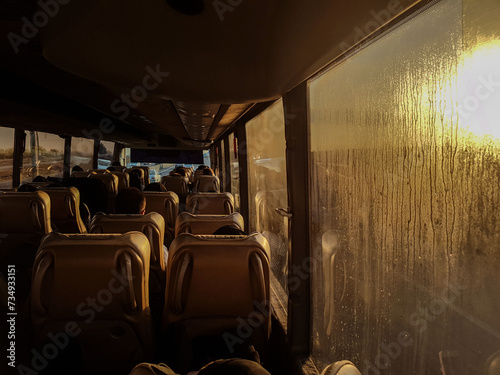 A beautiful view from the end of the bus, where the sunset light has made the space inside it into a silhouette