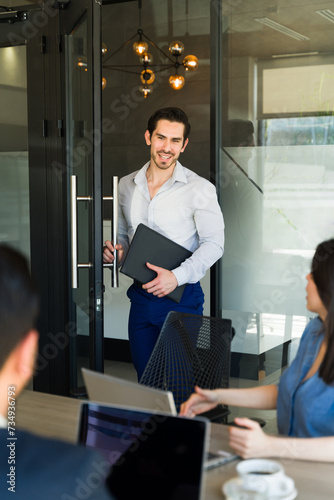 Businessman arriving late to a meeting and getting inside the room