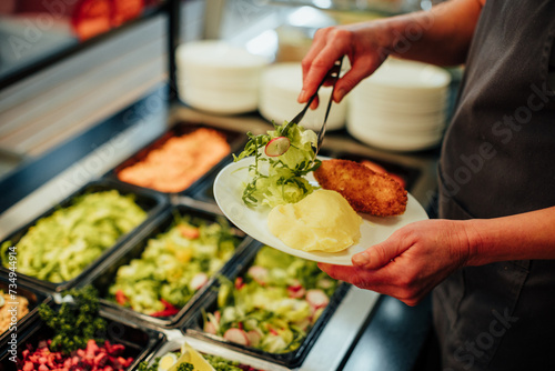 Obraz na plátně Buffet food serving process of own choice
