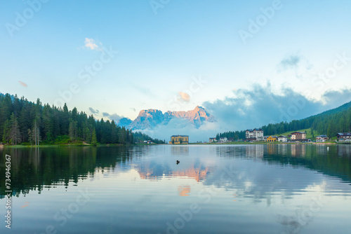 Lake Misurina in Dolomites mountain, Italian Alps, Belluno, Italy. Alpine Lago di Misurina with reflection and building on lakeside at sunrise near Cortina dAmpezzo . Mountain resort