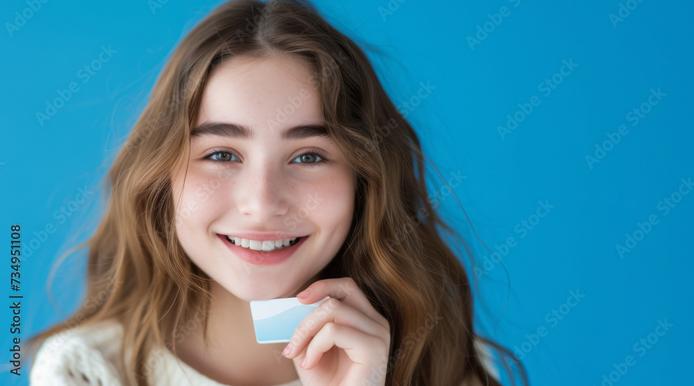 smiling child holding a blank card, on a blue background smiling child holding a blank card, on a blue background