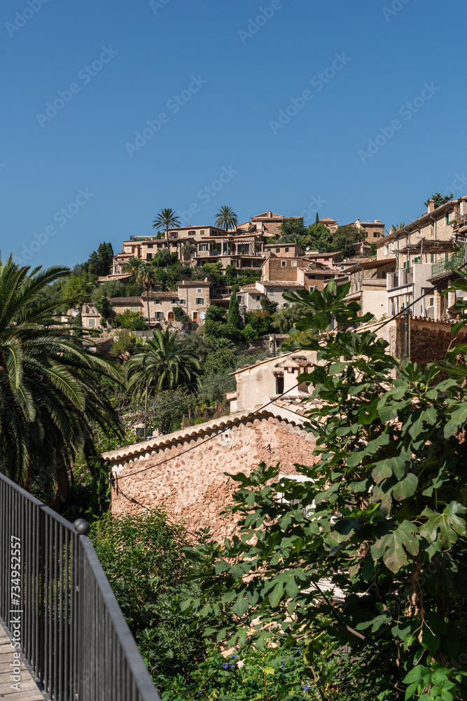a view to historical stone houses between trees a view to historical stone houses between trees