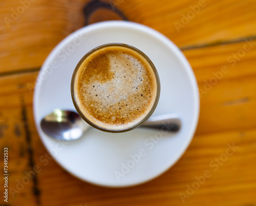 Image of cup of fresh coffee cortado on table, no people