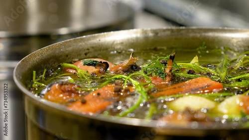 Close-up of a pot of boiling broth. Cooking soup in a restaurant