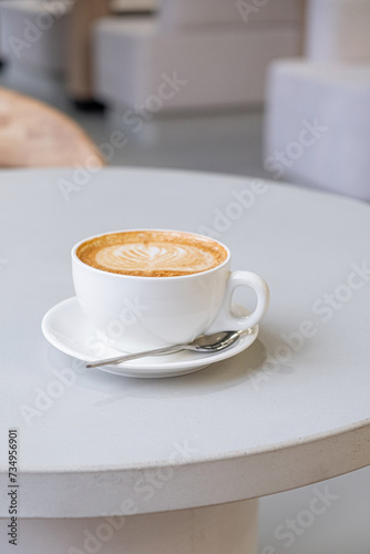 cup of cappuccino on table photo