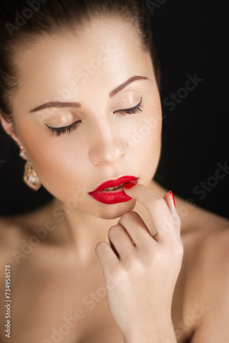 Close-up portrait of a beautiful girl on a dark background