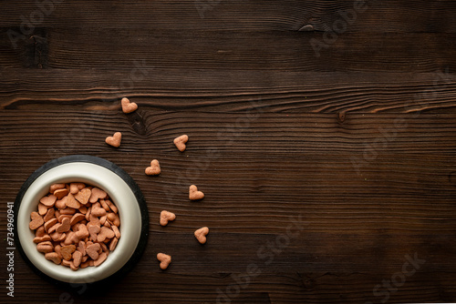 Food and treats for pets - biscuits in a shape of heart in a bowl