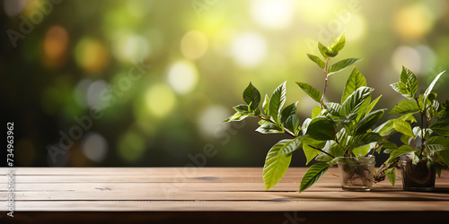 Wooden table with fresh green leaves on bokeh background.