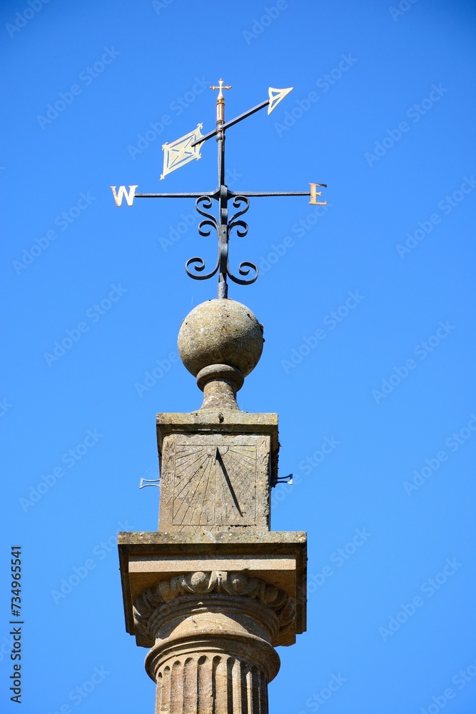 View of the top part of the Market Cross (also known as the Pinnacle Monument) along Church street in the town centre, Martock, Somerset, UK, Europe