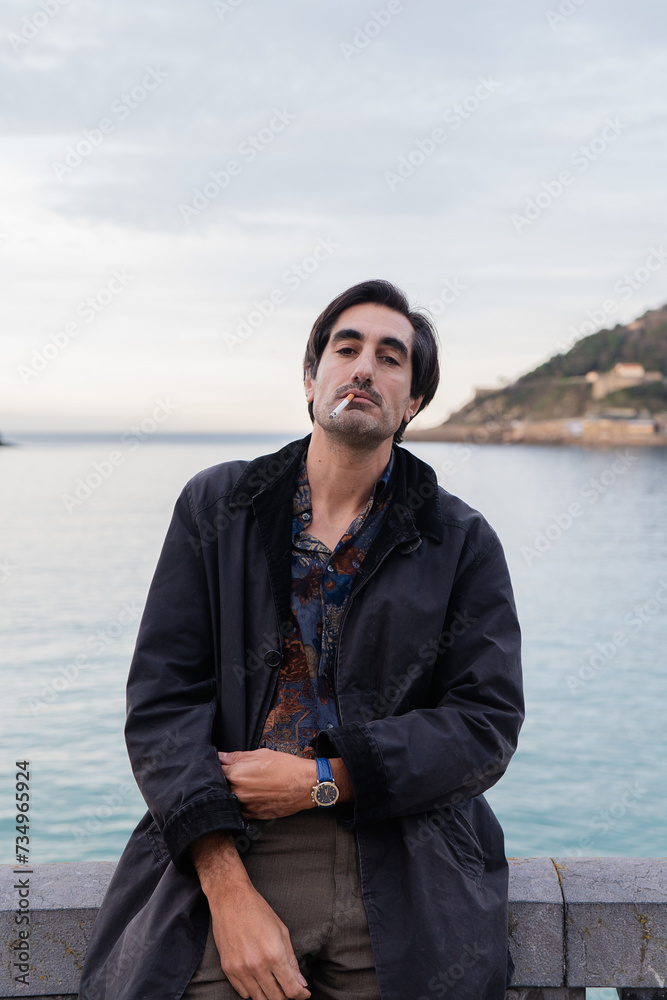Contemplative man smoking by the sea Contemplative man smoking by the sea